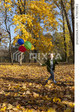 red-haired boy in autumn park 47993961