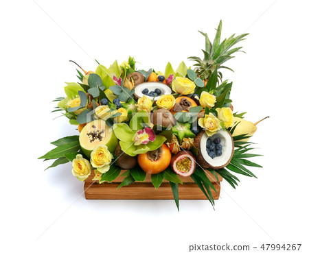 Wooden box with lots of exotic fruits and flowers 47994267