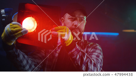Cameraman testing light equipment 47994438