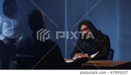 Investigators interrogating a criminal Investigators interrogating a criminal 47995037