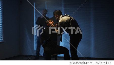 Policemen using excessive force during interrogation Policemen using excessive force during interrogation 47995148