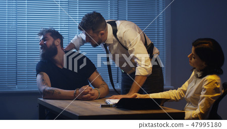 Violent policeman interrogating criminal about drugs Violent policeman interrogating criminal about drugs 47995180