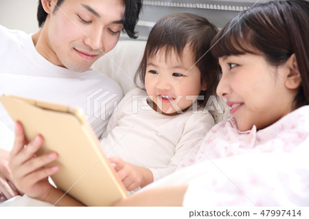 Young family entering the bed 47997414