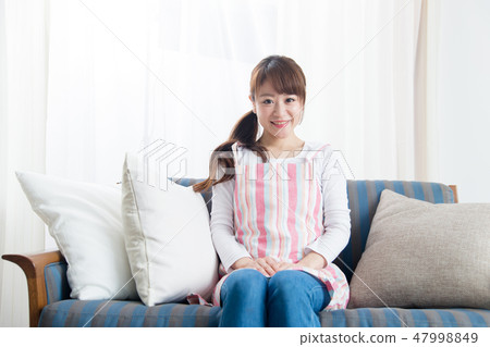 A woman / sofa in an apron A woman / sofa in an apron 47998849