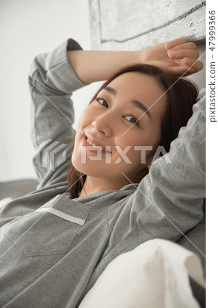 A waking woman in bed 47999366