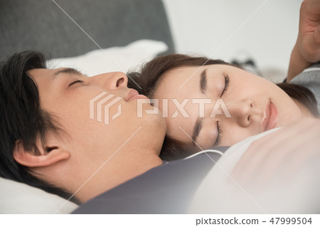 睡在床上的一對夫婦 47999504