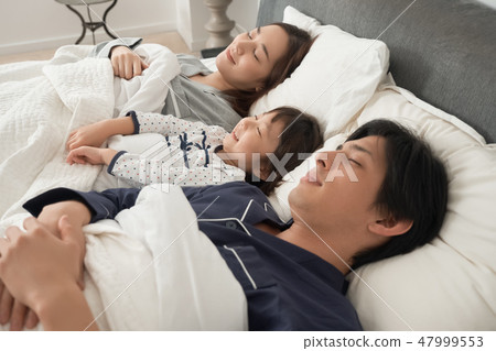 父母和孩子睡在床上 47999553