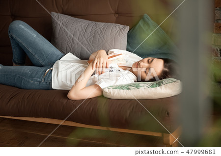 Woman relaxing in the living room 47999681