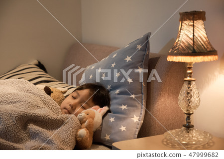 Child sleeping in bed 47999682