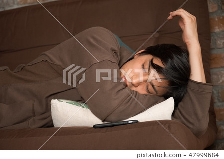 A man relaxing in the living room A man relaxing in the living room 47999684