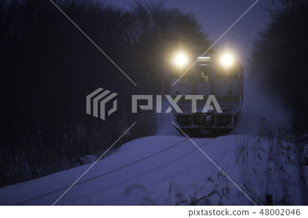 Early morning local train running in the snow Early morning local train running in the snow 48002046