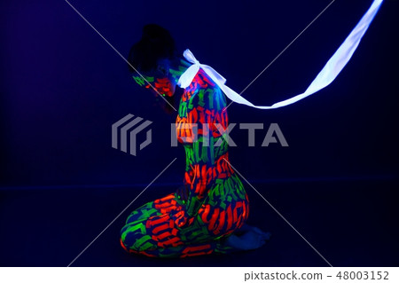 Girl with beautiful UV bodyart profile shot Girl with beautiful UV bodyart profile shot 48003152