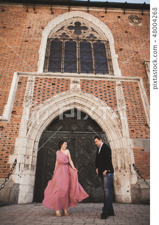 Elegant beautiful wedding couple posing near a church. Krakow Elegant beautiful wedding couple posing near a church. Krakow 48004268