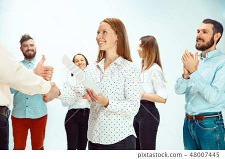 Boss approving and congratulating young successful employee 48007445