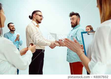 Boss approving and congratulating young successful employee Boss approving and congratulating young successful employee 48007602