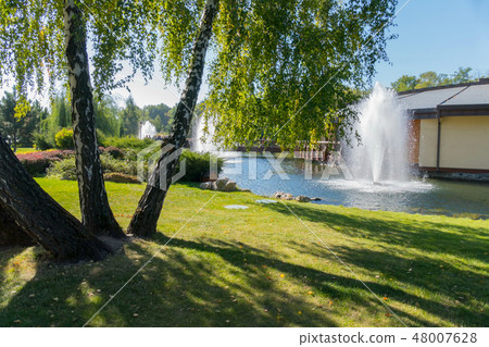 A high fountain of white, foamy water fountain and 48007628