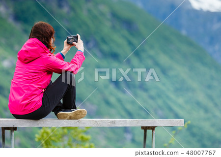 Tourist with camera looking mountains Norway Tourist with camera looking mountains Norway 48007767