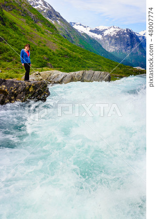 Tourist woman by Videfossen Waterfall in Norway 48007774