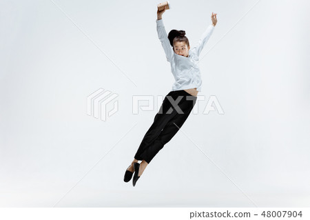 Happy business woman dancing and smiling isolated on white. Happy business woman dancing and smiling isolated on white. 48007904