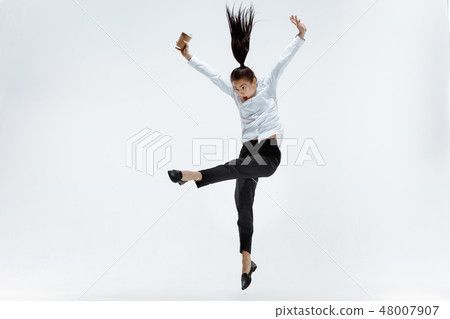 Happy business woman dancing and smiling isolated on white. Happy business woman dancing and smiling isolated on white. 48007907
