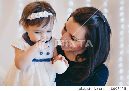 Woman holding a child Woman holding a child 48008426