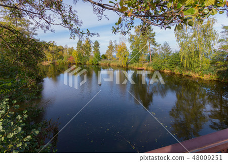 wooden bridge across the lake with shores cropped 48009251