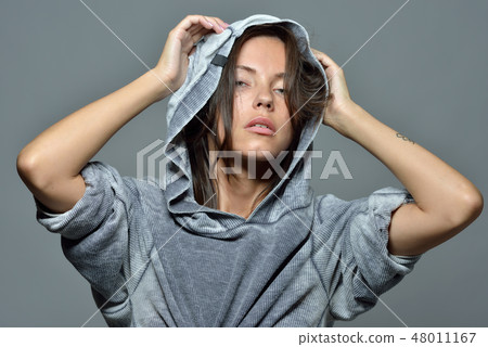 Portrait of the beautiful woman in hoody blouse. Portrait of the beautiful woman in hoody blouse. 48011167