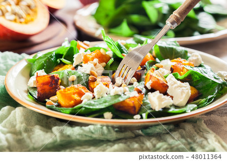 Roasted pumpkin salad with spinach and nuts Roasted pumpkin salad with spinach and nuts 48011364