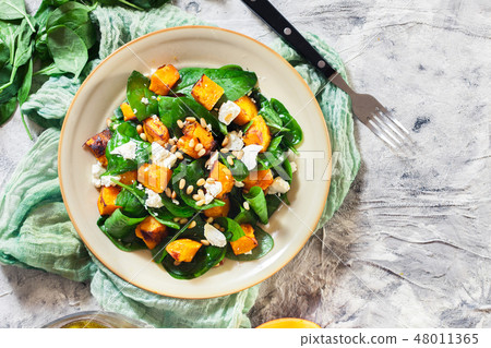Roasted pumpkin salad with spinach and nuts Roasted pumpkin salad with spinach and nuts 48011365
