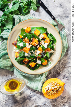 Roasted pumpkin salad with spinach and nuts Roasted pumpkin salad with spinach and nuts 48011366