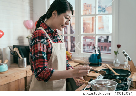 girl holding spoon stirring soft melted chocolate 48012084