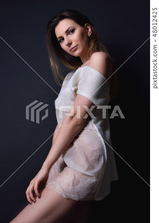 beautiful woman with long  hair in white transparent blouse. 48012425