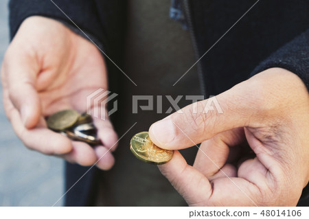man with some czech koruna coins in his hands 48014106