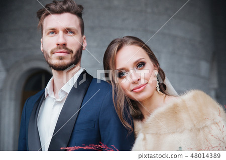 Wedding couple hugging each other indoor. Close-up portrait of wedding couple . Beauty bride with Wedding couple hugging each other indoor. Close-up portrait of wedding couple . Beauty bride with 48014389