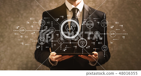 LiFi theme with businessman holding a tablet computer  48016355