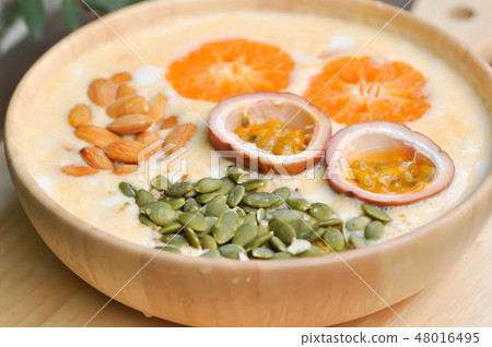 orange yogurt with fruit topping 48016495