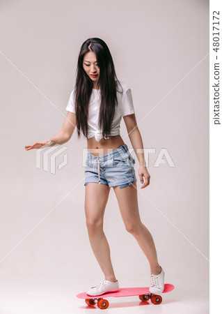 beautiful asian woman in sunglasses with skateboard beautiful asian woman in sunglasses with skateboard 48017172