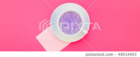 Cup of beautiful lilac flowers infused water Cup of beautiful lilac flowers infused water 48018403