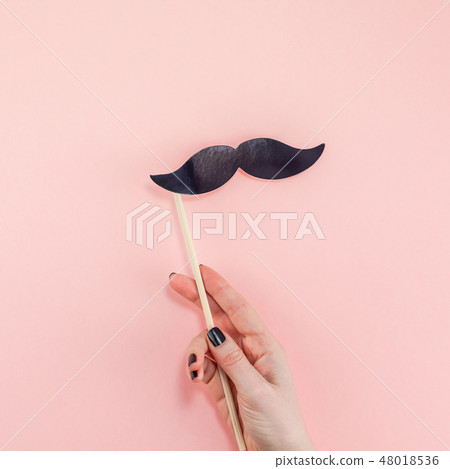 Woman hands with black paper moustaches 48018536