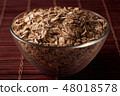 oat flakes in a glass bowl 48018578