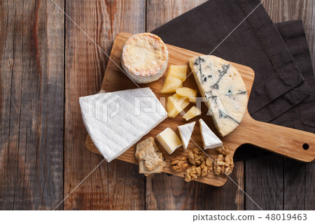 Tasting cheese dish on a wooden background. Tasting cheese dish on a wooden background. 48019463