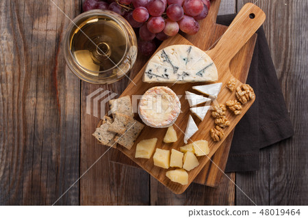 Tasting cheese dish on a wooden background. Tasting cheese dish on a wooden background. 48019464