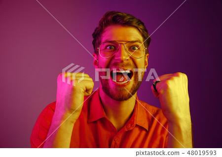 Winning success man happy ecstatic celebrating being a winner. Dynamic energetic image of male model 48019593