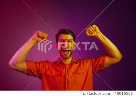 Winning success man happy ecstatic celebrating being a winner. Dynamic energetic image of male model Winning success man happy ecstatic celebrating being a winner. Dynamic energetic image of male model 48019598