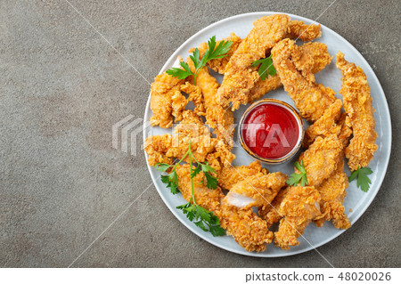 Breaded chicken strips with sauce. 48020026
