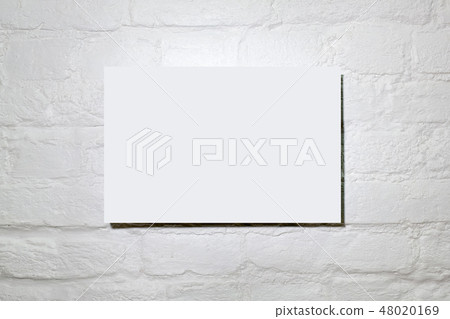 White blank poster in a white brick wall. White blank poster in a white brick wall. 48020169