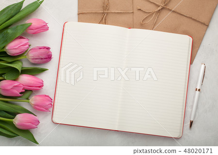 Blank note pad with pen and tulips. Blank note pad with pen and tulips. 48020171