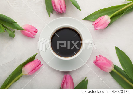 Black coffee in white Cup and tulips. Black coffee in white Cup and tulips. 48020174
