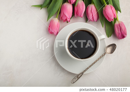Black coffee in white Cup and tulips. Black coffee in white Cup and tulips. 48020177