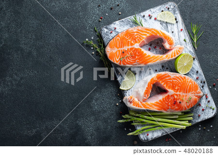 Two raw fresh salmon or trout steaks. 48020188